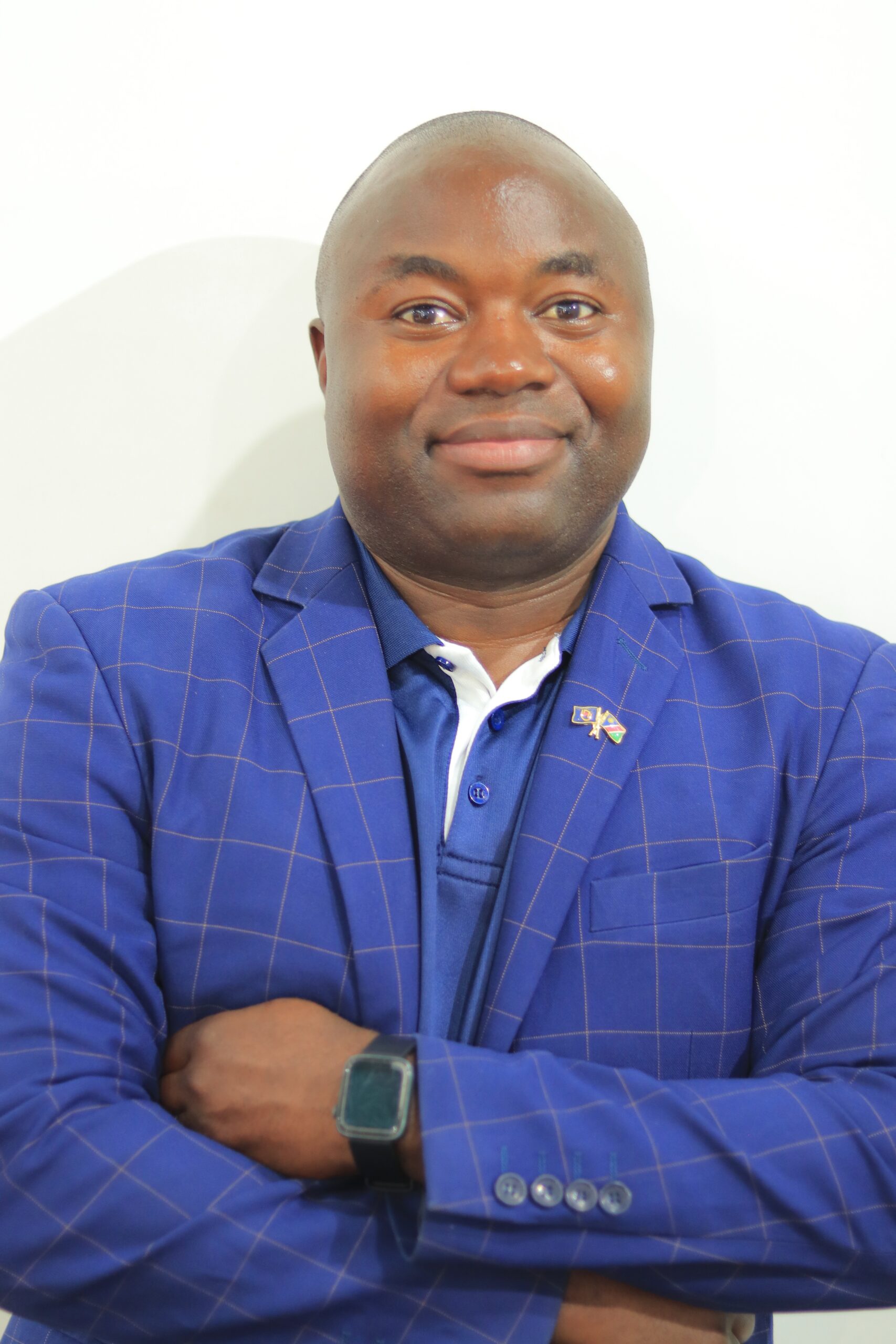 Prof Attlee Munyaradzi Gamundani smiling, wearing a blue checked jacket